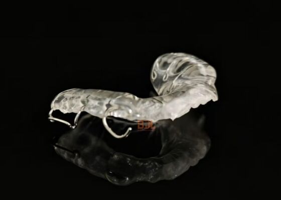 Orthodontic Retainer with Transparent Acrylic Base and Stainless Steel Clasps for Post Orthodontic Teeth Stabilization